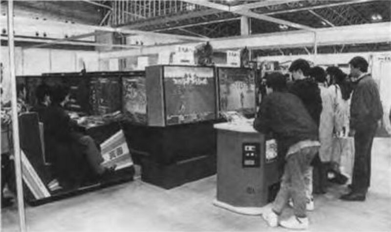 File:Daisho shokai booth at aou92 demoing tenga (left) and tachi tenga 4-2 (right) projector arcade cabinets.jpg